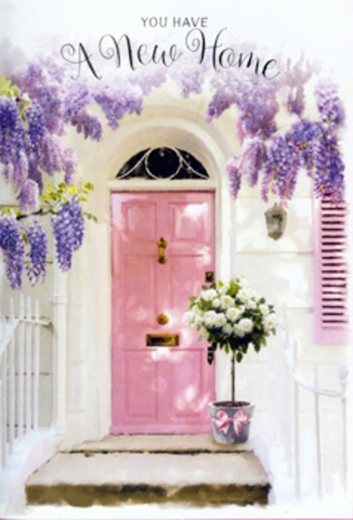Stepping into this image feels like turning into a peaceful side street off Spitalfields Market, where a single doorway tells a story of homecoming and gentle transformation. Above the entrance, mature wisteria winds its way along unseen supports, pouring downward in cascades of lavender-hued flowers. These blossoms, clustered in loose, drooping cones, filter the daylight so that it falls in soft, scattered patches across the doorway, reminiscent of the way light dances through trees on a quiet morning walk from Liverpool Street. The front door itself is painted a calm, pastel pink, its panels smooth and subtly reflective, giving off a welcoming, almost tender glow. A whitewashed wall and a coordinating pink shutter frame the scene, creating a backdrop that feels simple yet considered, much like the curated interiors hidden behind many Spitalfields facades. On the doorstep, a sturdy tin bucket has been transformed into an elegant vessel for a lush arrangement of roses. The blooms are creamy white with hints of ivory at their centres, opened just enough to show off their layered petals without losing their rounded, classic shape. Flecks of fresh green foliage nestle among them, softening the edges and adding a touch of garden-like spontaneity. A satin ribbon in a gentle pink tone wraps around the bucket, tied carefully into a bow whose tails rest lightly against the metal. The textures in the scene-the roughness of the stone step, the smooth paint, the feathery leaves, the velvet petals-combine to create a tactile sense of place. The overall mood is quiet yet hopeful, ideal for a new home floral design meant to celebrate moving into a Spitalfields flat, or for a card that captures the feeling of standing at your own front door for the very first time.